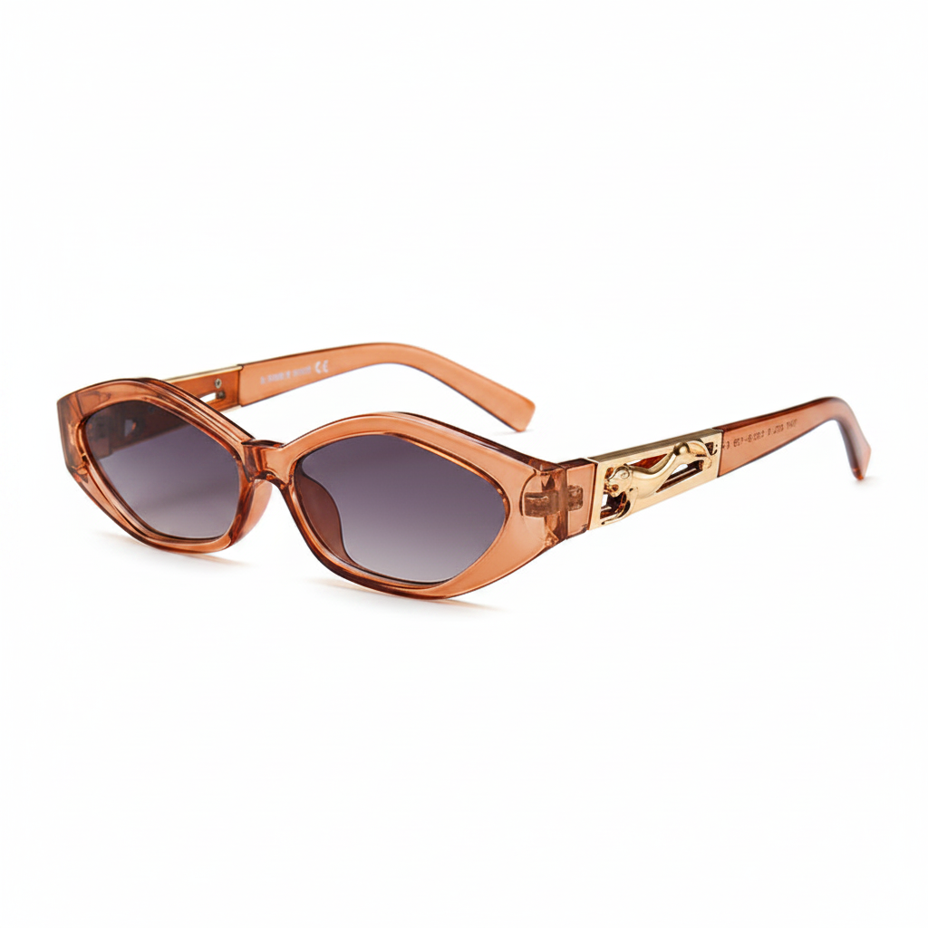 Oval sunglasses with a translucent copper-orange frame and gradient gray lenses, featuring a decorative gold-toned metal emblem on the temple arm.