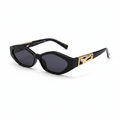 Oval sunglasses with a black frame and gradient gray lenses, featuring a decorative gold-toned metal emblem on the temple arm.